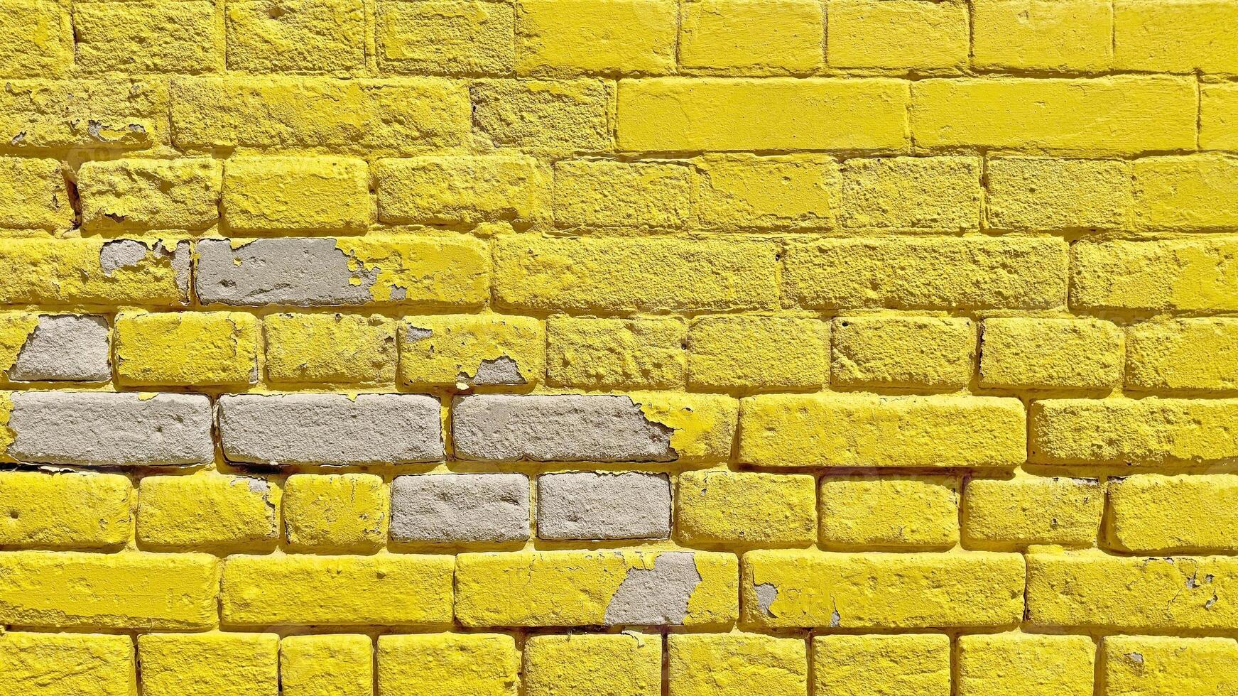 The texture of the brick wall of many rows of bricks painted in yellow color. photo