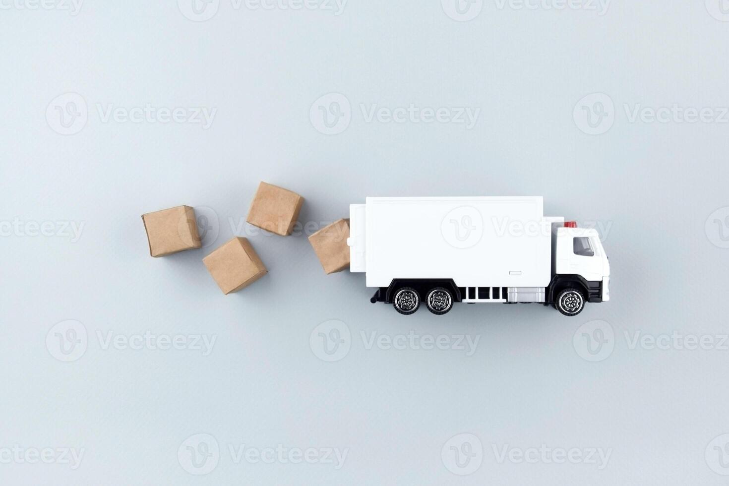 White toy truck with boxes on a light background, space for text. photo