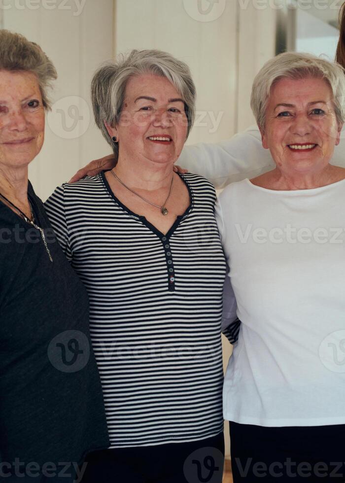 A vibrant community of senior women, guided by their instructor, embraces the enriching journey of yoga, fostering unity, well-being, and a shared commitment to active aging photo