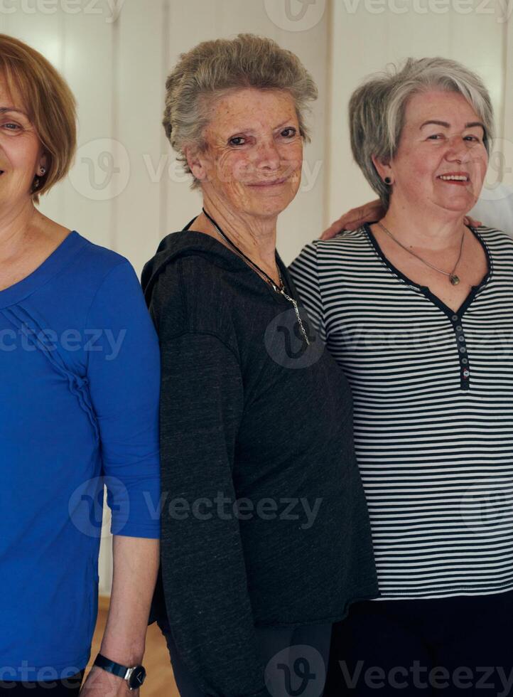 A vibrant community of senior women, guided by their instructor, embraces the enriching journey of yoga, fostering unity, well-being, and a shared commitment to active aging photo