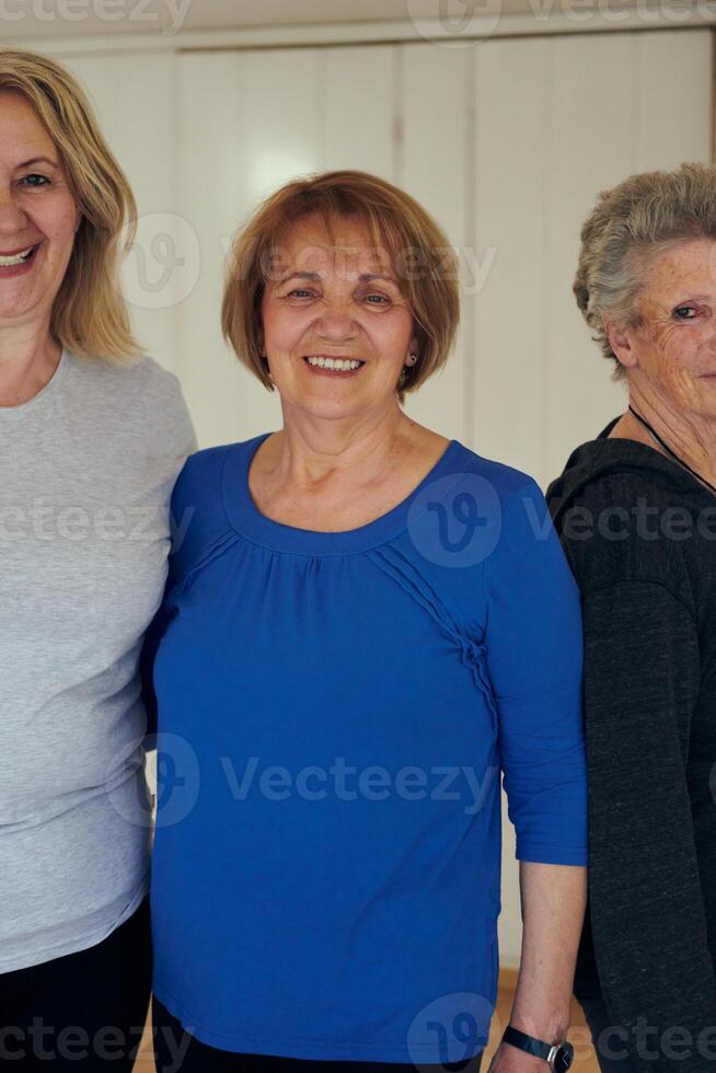 A vibrant community of senior women, guided by their instructor, embraces the enriching journey of yoga, fostering unity, well-being, and a shared commitment to active aging photo
