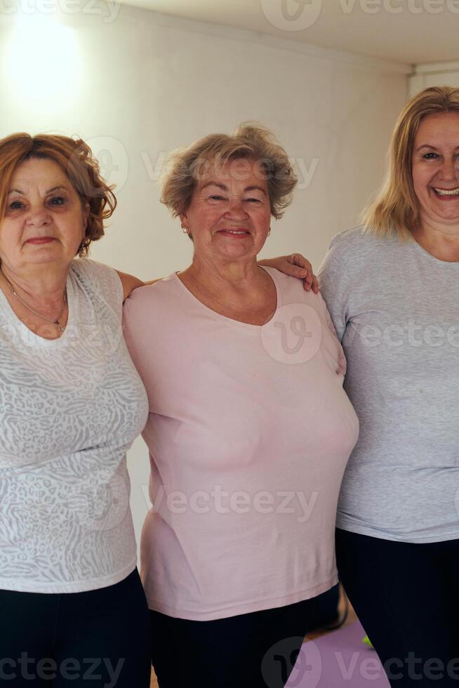 A vibrant community of senior women, guided by their instructor, embraces the enriching journey of yoga, fostering unity, well-being, and a shared commitment to active aging photo