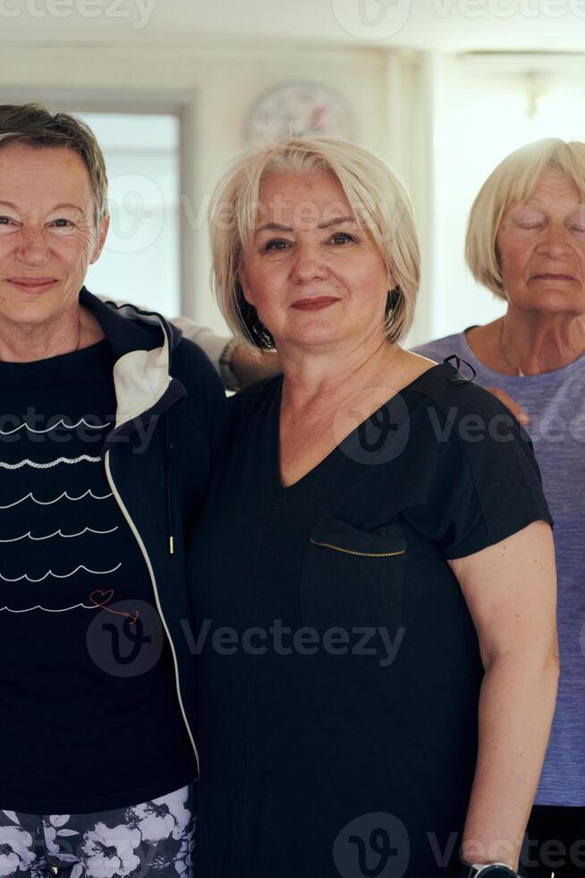 A vibrant community of senior women, guided by their instructor, embraces the enriching journey of yoga, fostering unity, well-being, and a shared commitment to active aging photo