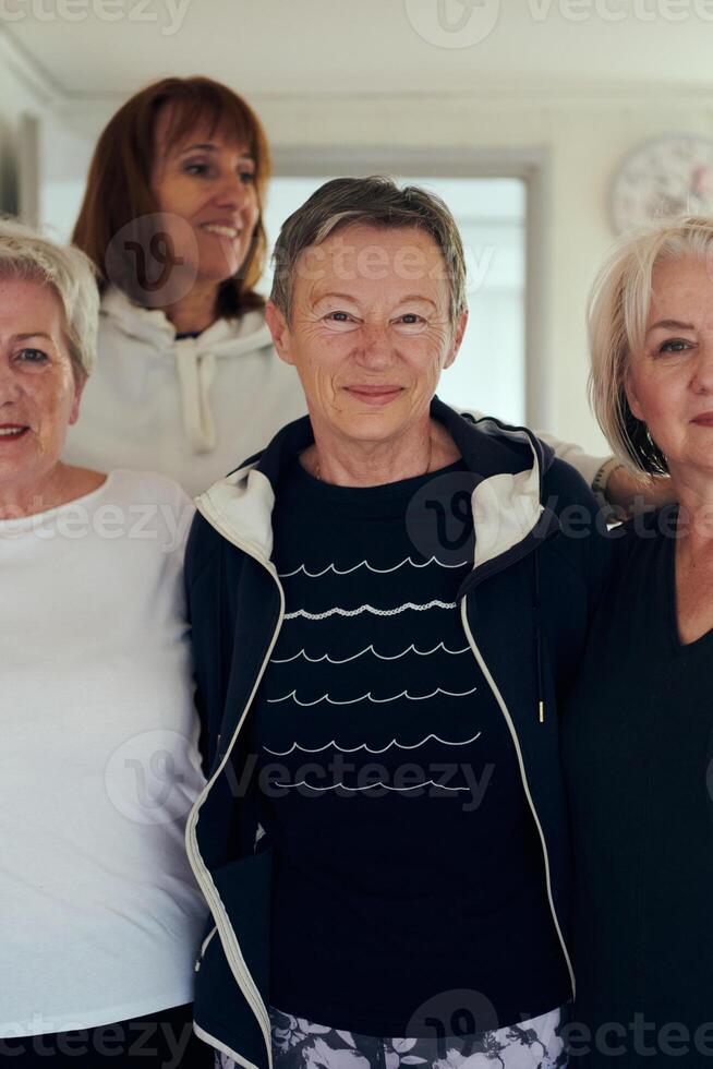 A vibrant community of senior women, guided by their instructor, embraces the enriching journey of yoga, fostering unity, well-being, and a shared commitment to active aging photo