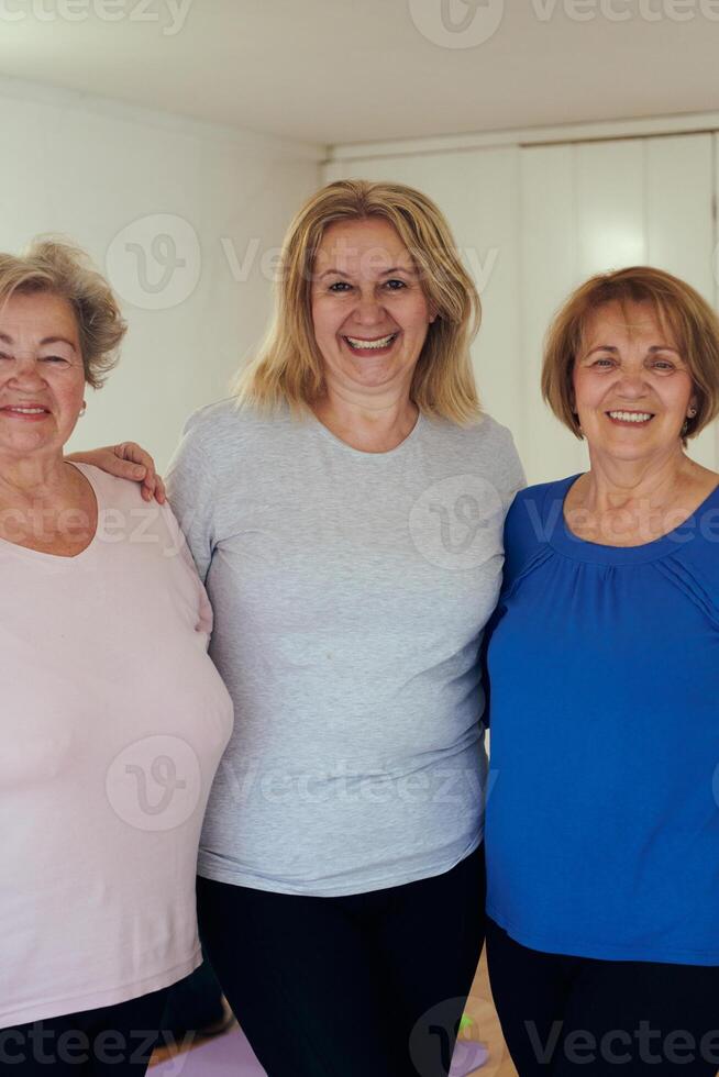 A vibrant community of senior women, guided by their instructor, embraces the enriching journey of yoga, fostering unity, well-being, and a shared commitment to active aging photo