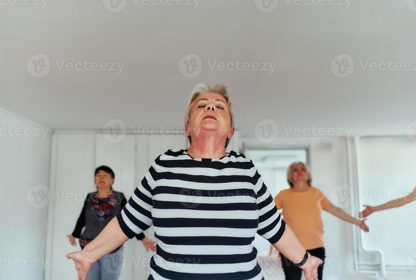 Senior Women Embrace Wellness. Yoga and Stretching in a Sunlit Space photo