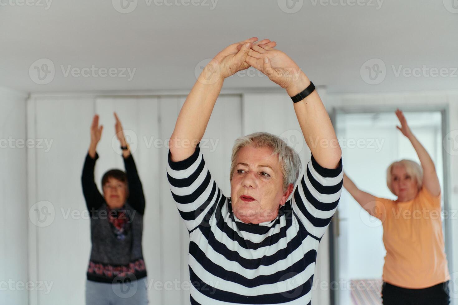 Senior Women Embrace Wellness. Yoga and Stretching in a Sunlit Space photo