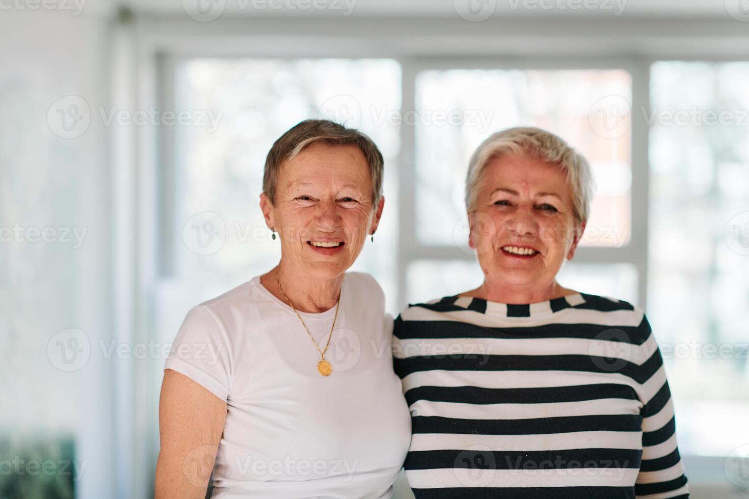 Two older friends embrace joyfully in a hug after completing a successful workout session together. photo