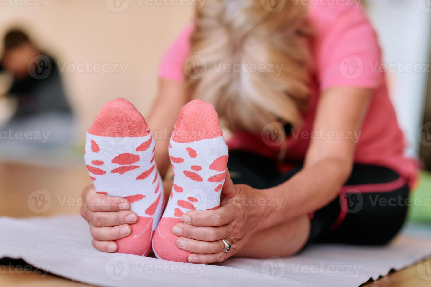 Senior Woman Practicing Back Stretches in a Sunlit Space for Optimal Health and Well Being photo