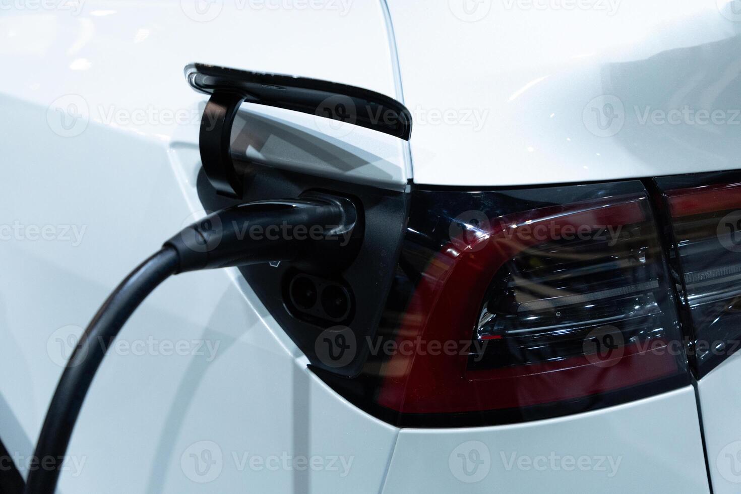 Closeup EV charger handle plugged in or connect to electric car photo