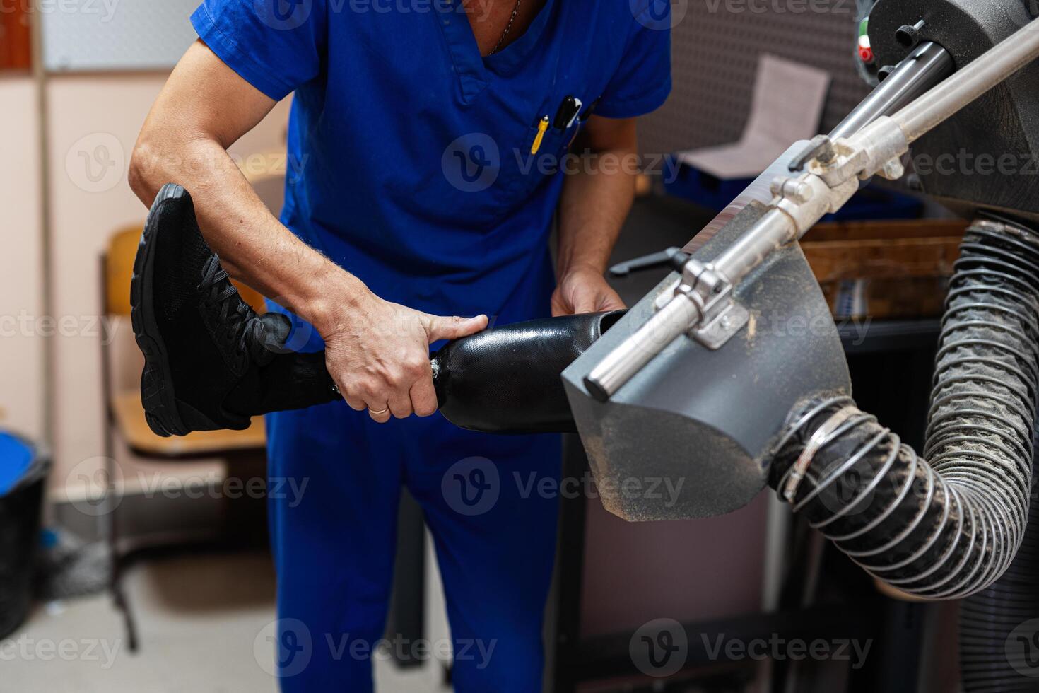 Technician adjusting prosthetic leg in a medical facility photo
