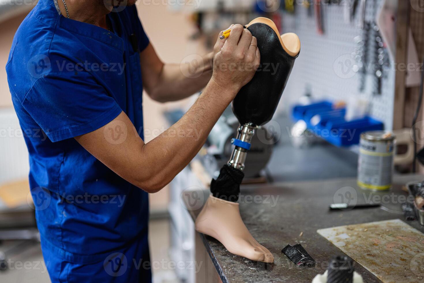 Technician crafting a prosthetic leg in workshop setting photo