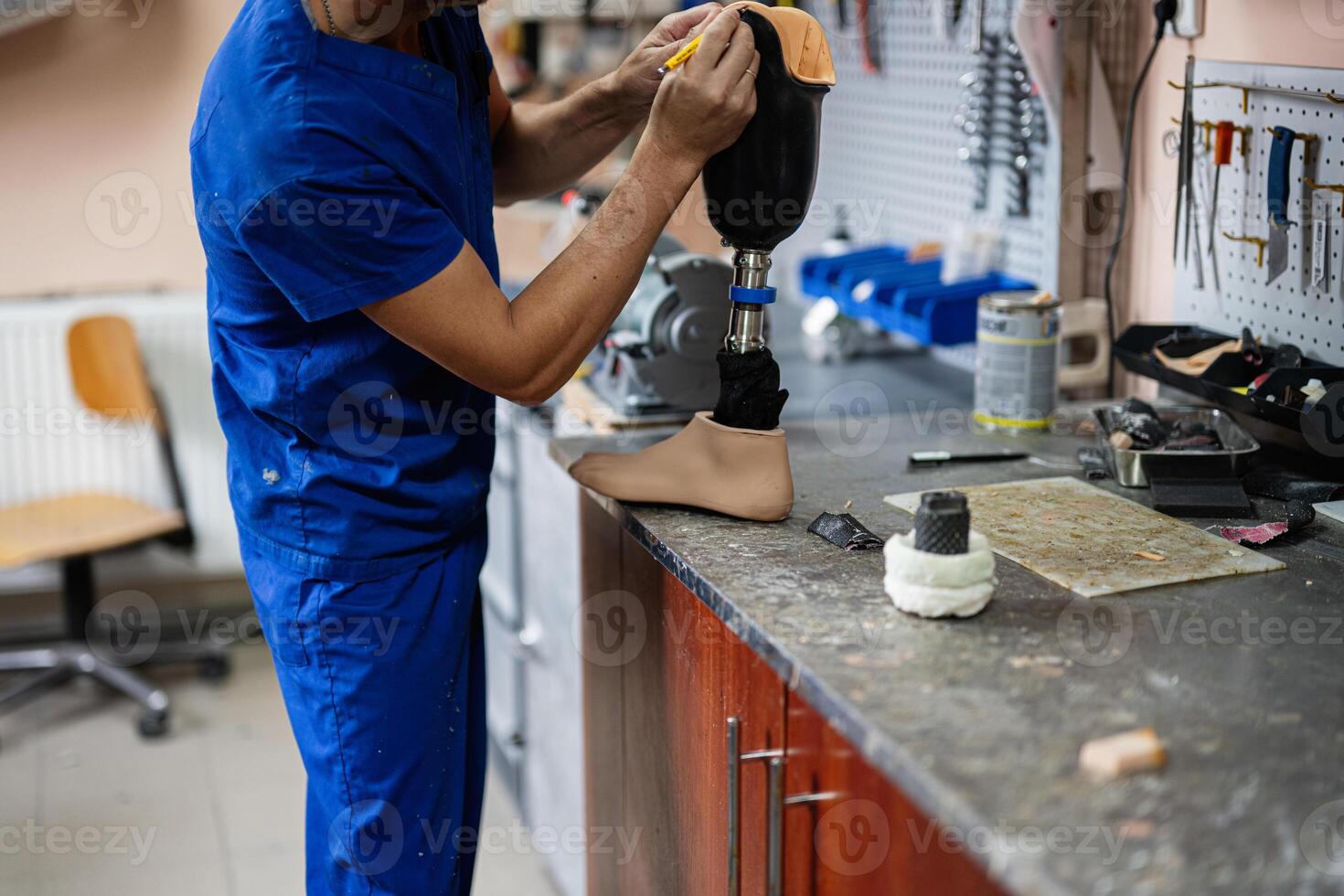 Technician assembling a prosthetic leg in workshop setting photo