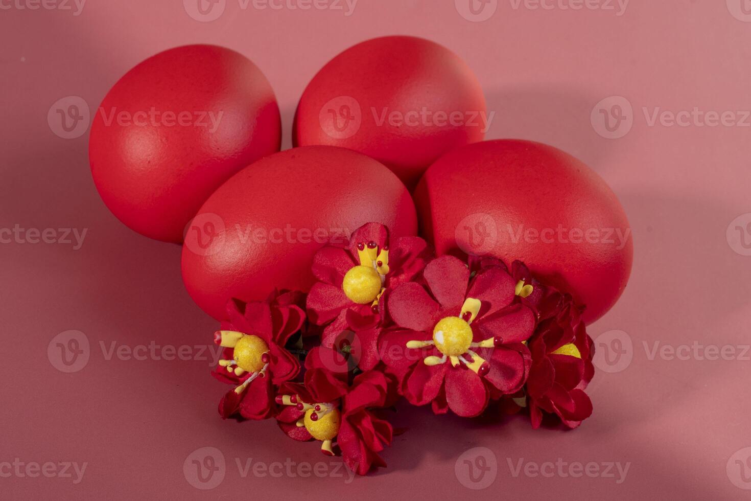 Colorful eggs, symbolizing Easter, on a colorful background and flowers photo