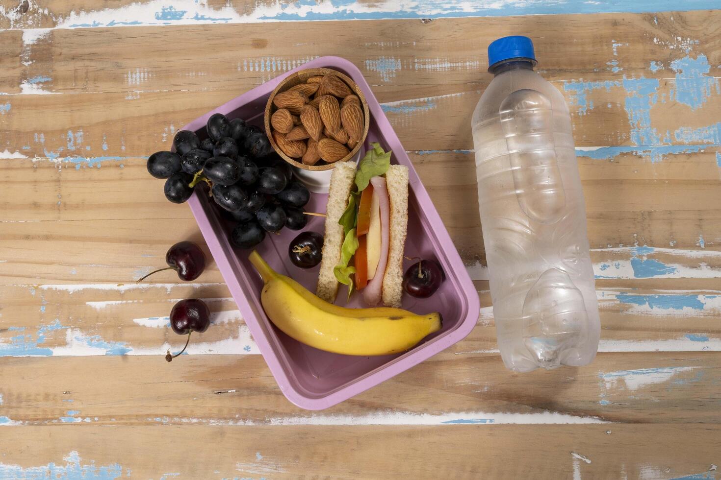 School lunch presentation. Top view showing lunch box filled with nutritious foods, protein, fruit and grains photo