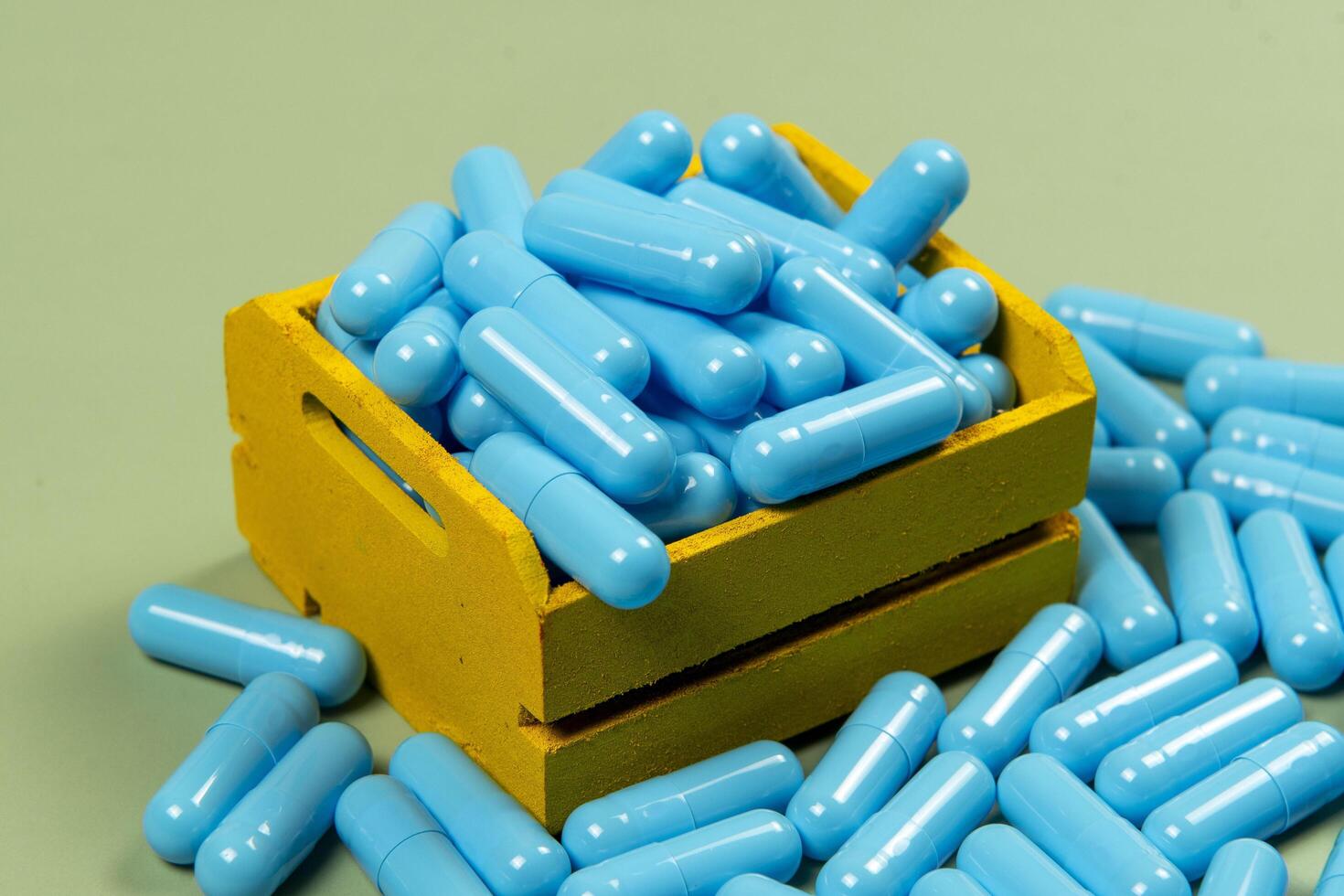 blue medicine capsule in miniature shopping cart photo