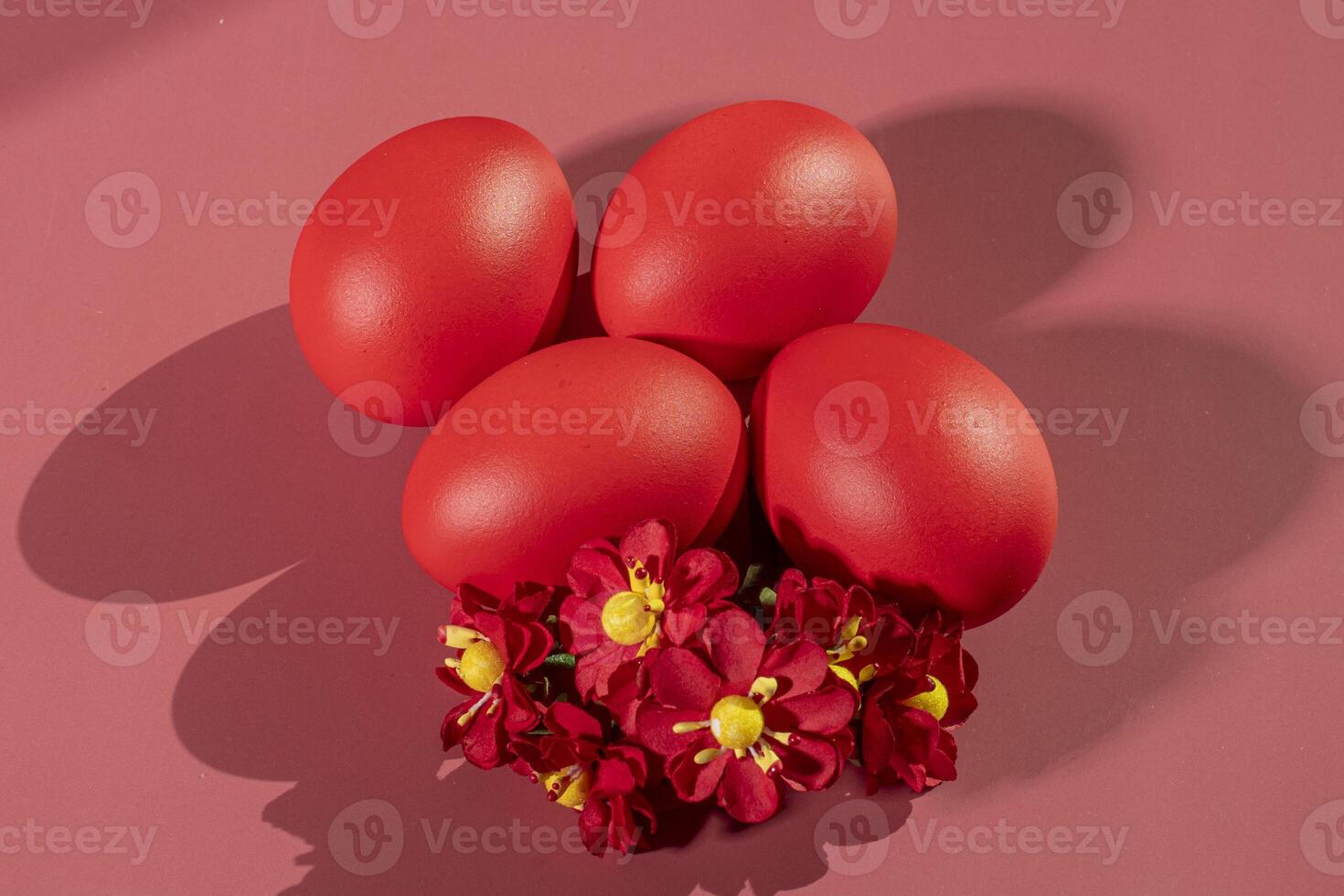 Colorful eggs, symbolizing Easter, on a colorful background and flowers photo