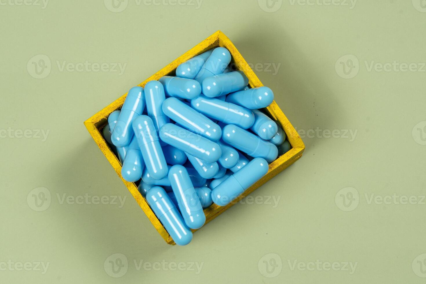 blue medicine capsule in miniature shopping cart photo