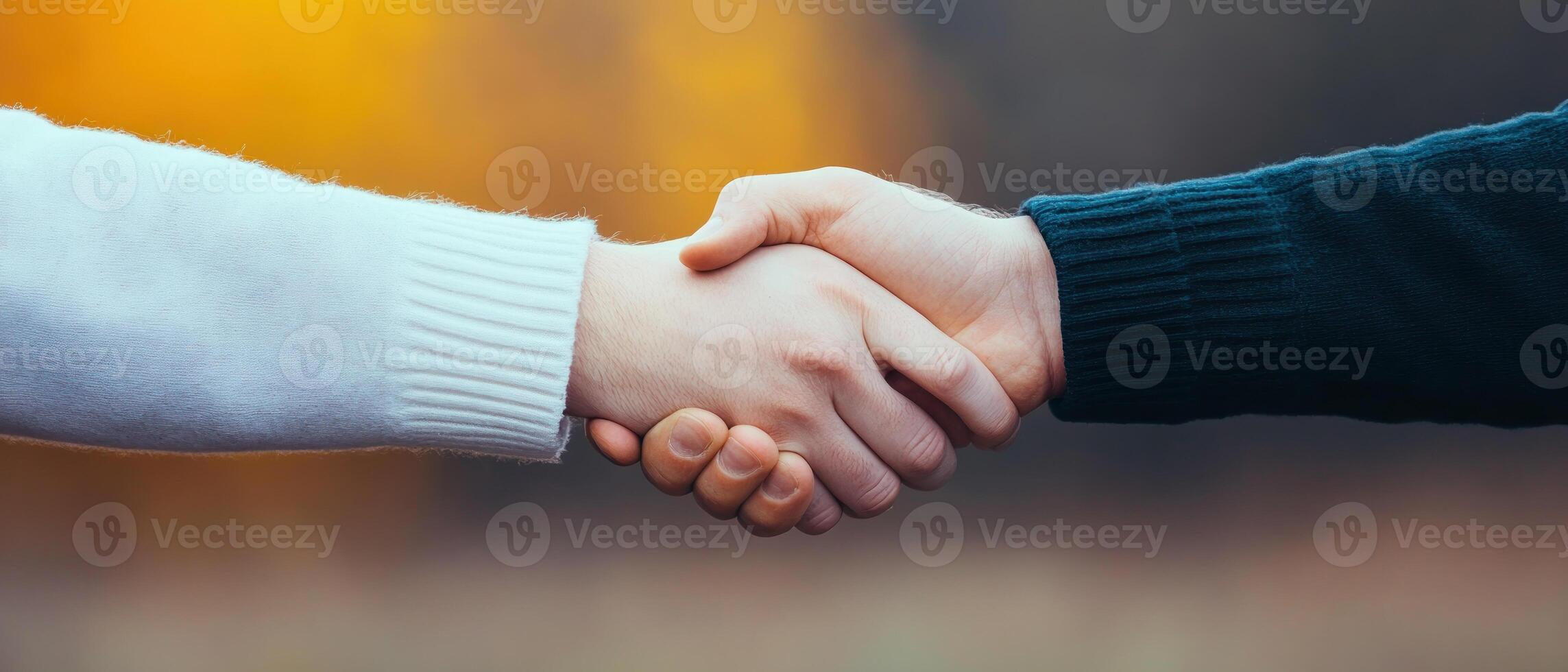 A warm handshake symbolizes connection and understanding between two individuals. photo