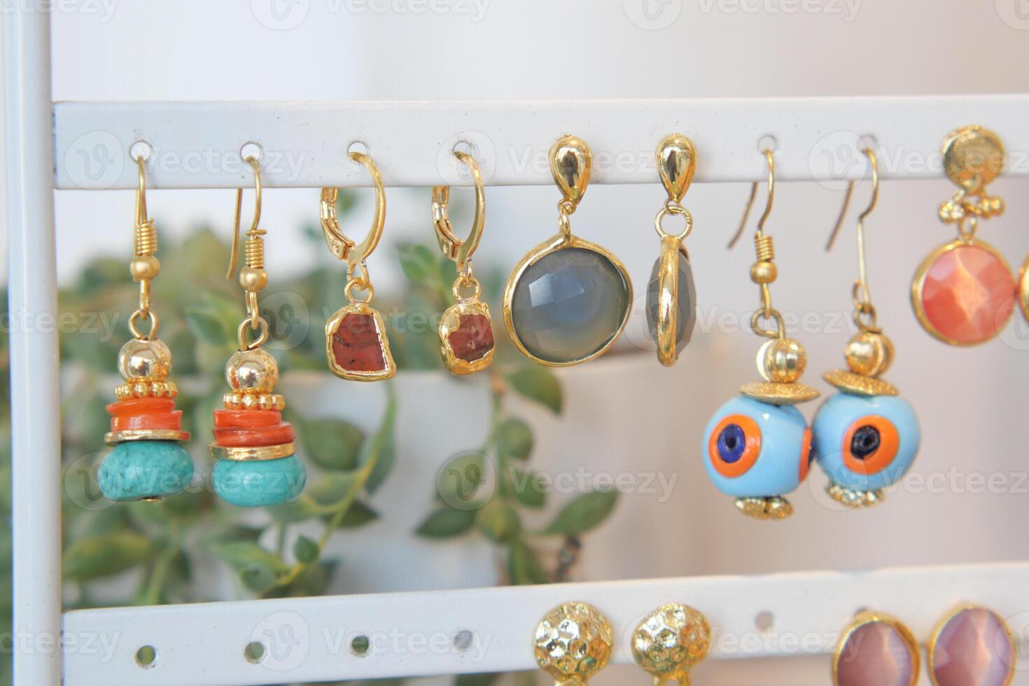 An Exquisite Collection of Beautifully Colorful Earrings Tastefully Displayed on a Stand photo