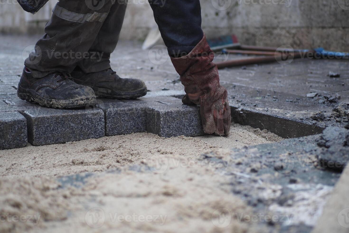 Laying Paving Stones on a Construction Site for a driveway or footpath requires skill and precision photo