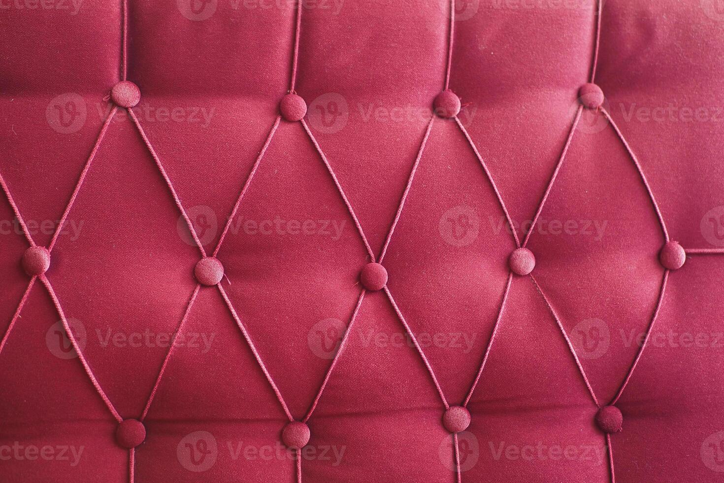 This is an elegant red upholstered fabric that features stylish buttontufted detailing photo