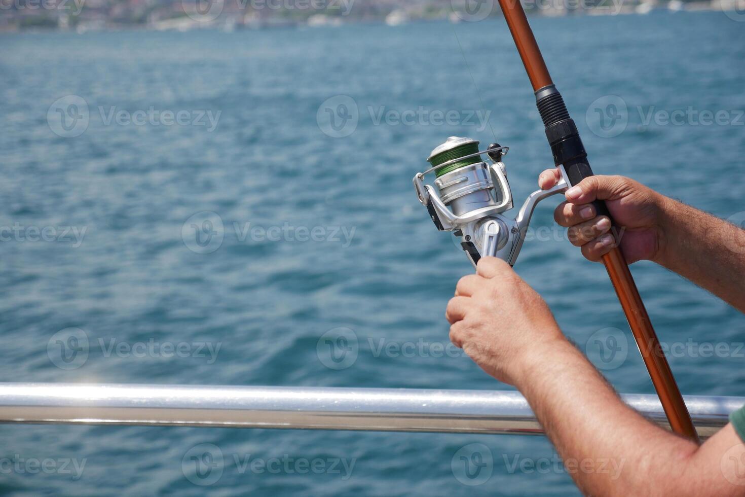 Fisherman with rod, spinning reel , photo