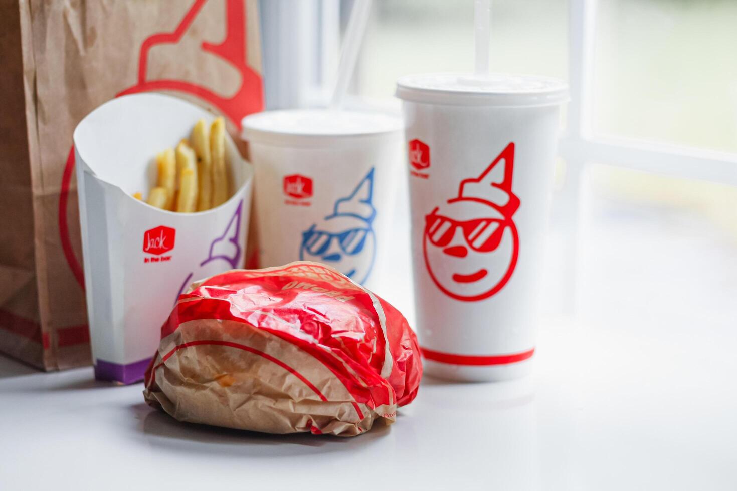 WASHINGTON, USA - August 08, 2024 - A Jack in the Box favorites. The crispy fries,burger, and sodas are ready to satisfy any craving. The bright colors photo