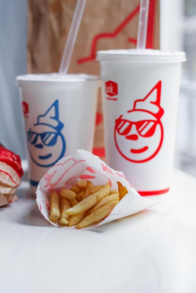 WASHINGTON, USA - August 08, 2024 - A Jack in the Box favorites. The crispy fries,burger, and sodas are ready to satisfy any craving. The bright colors photo