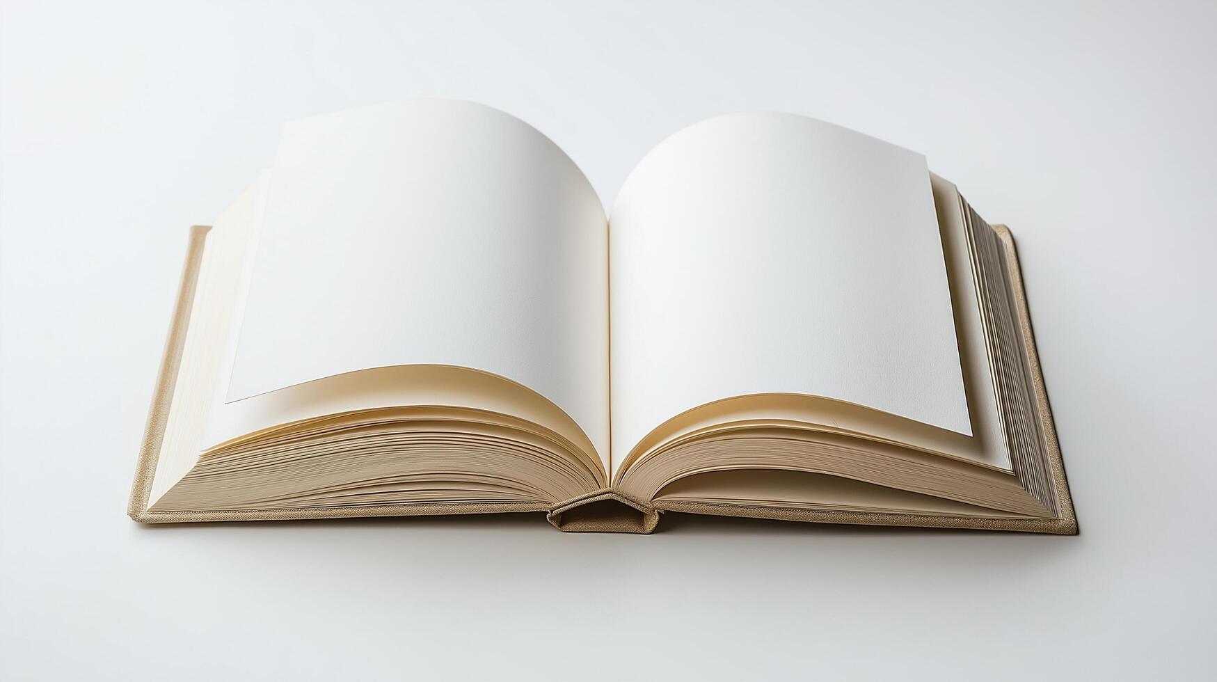 An open blank book with cream-colored pages laid flat on a white surface, ready for writing or creativity photo