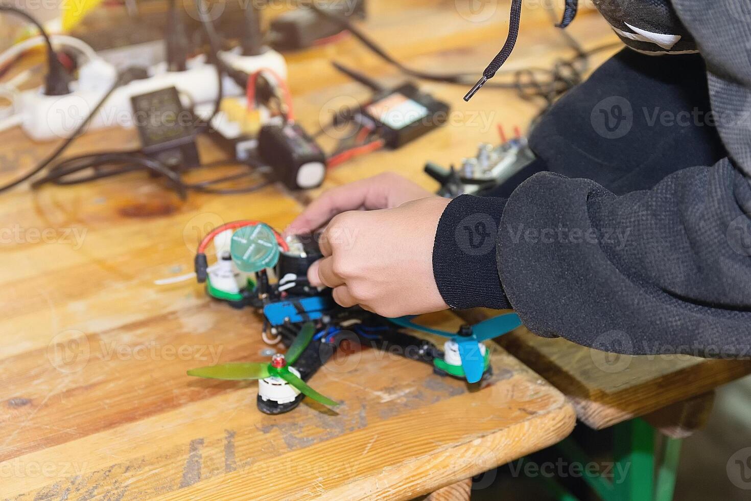 A man assembles and configures a high-speed drone photo