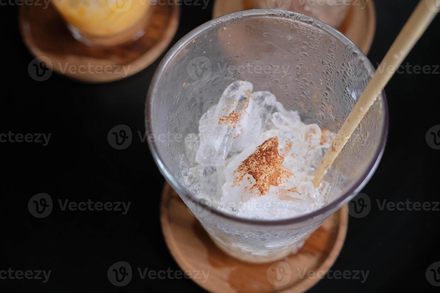 Top view of empty iced coffee glass on the wood coasters. photo