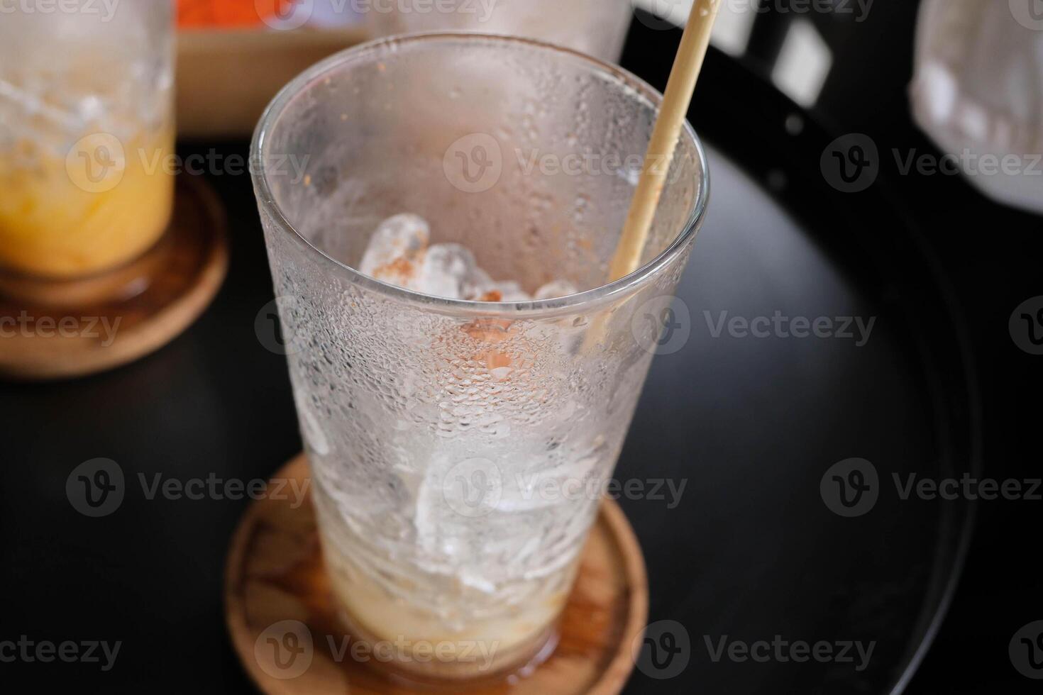 Empty ice coffee glass on the wood coasters. photo