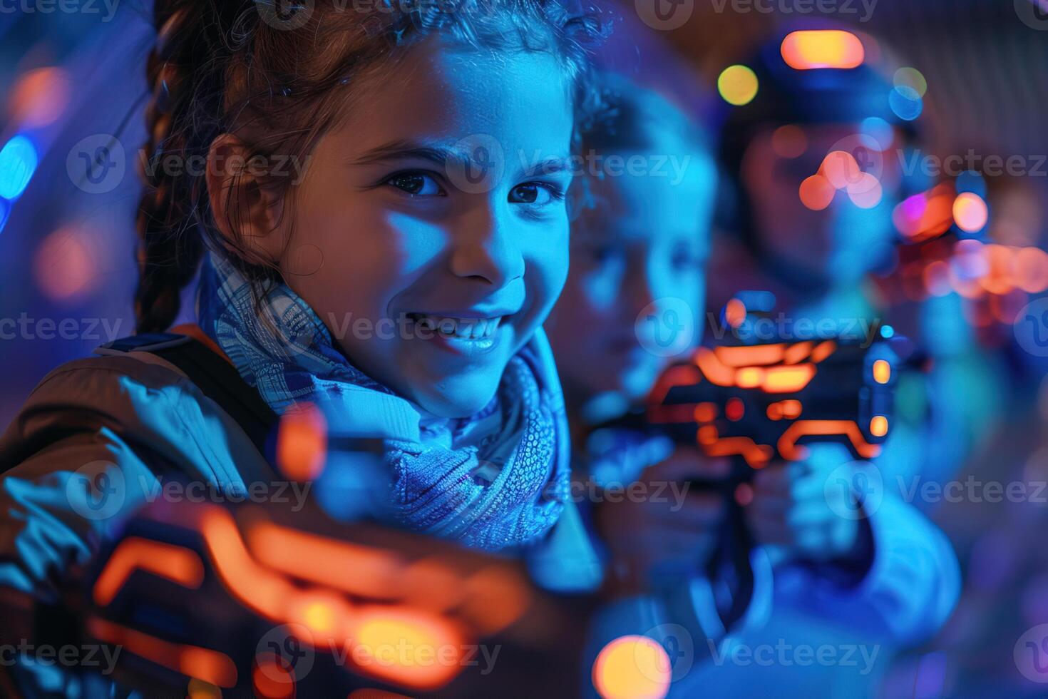 portrait of a little happy girl with toy gun playing in laser tag photo