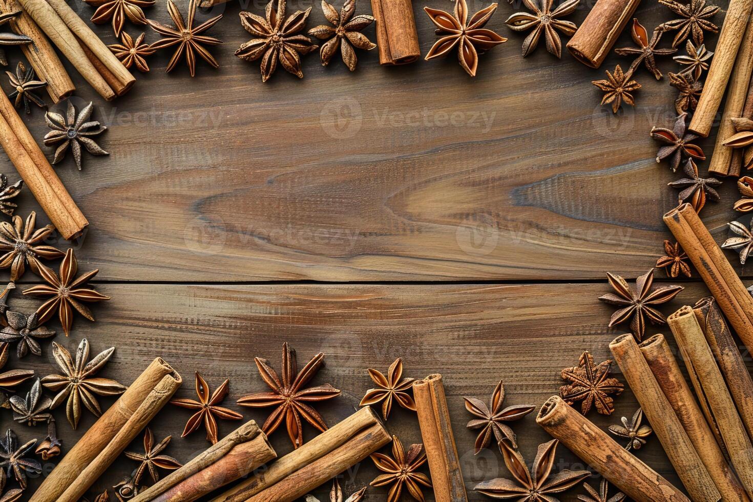 composition of cinnamon sticks and star anise border frame on wooden background top view template with copy space photo