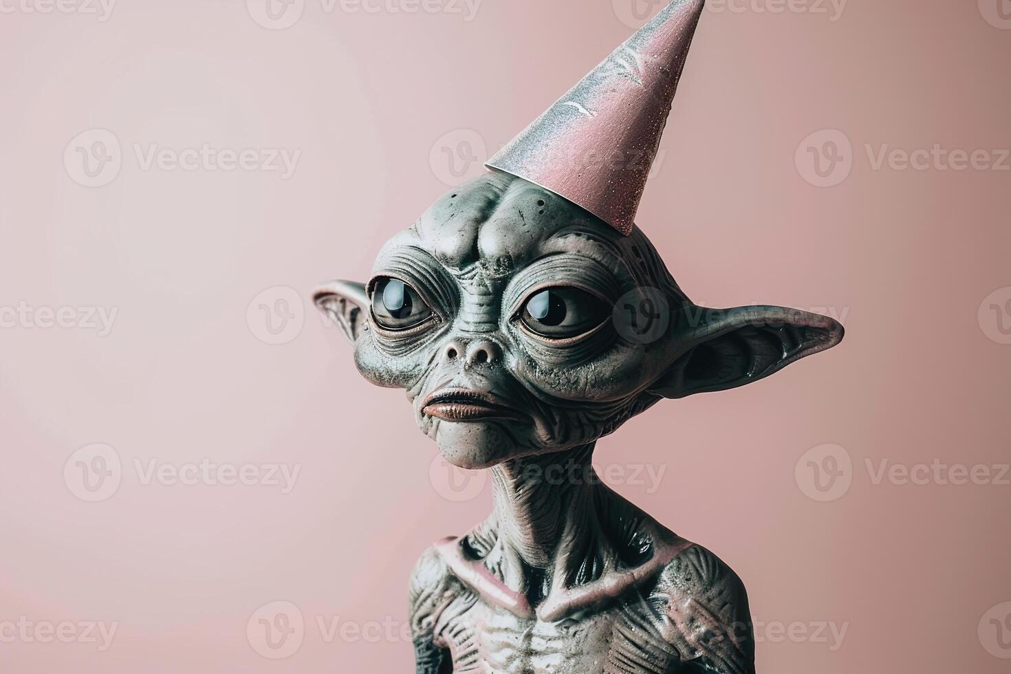 Birthday celebration concept portrait alien ufo in festive party hat on pink background photo