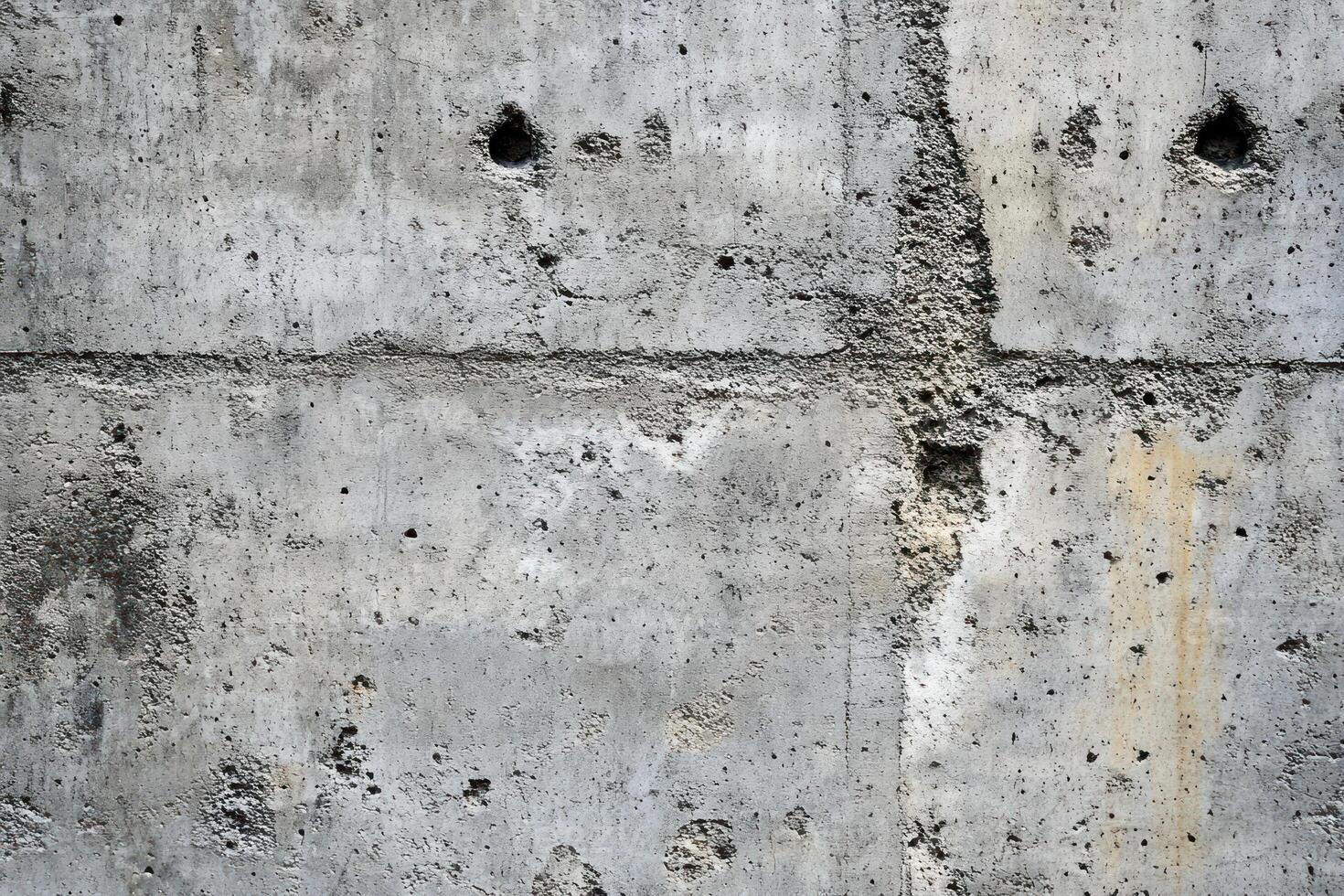 Weathered Concrete Wall with Holes and Cracks photo