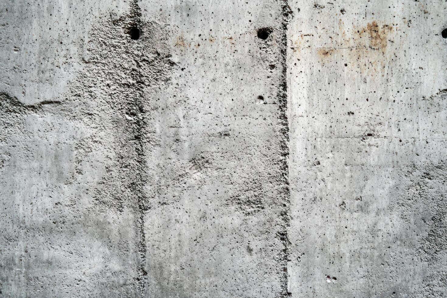 Weathered Concrete Wall with Vertical Lines and Patches photo