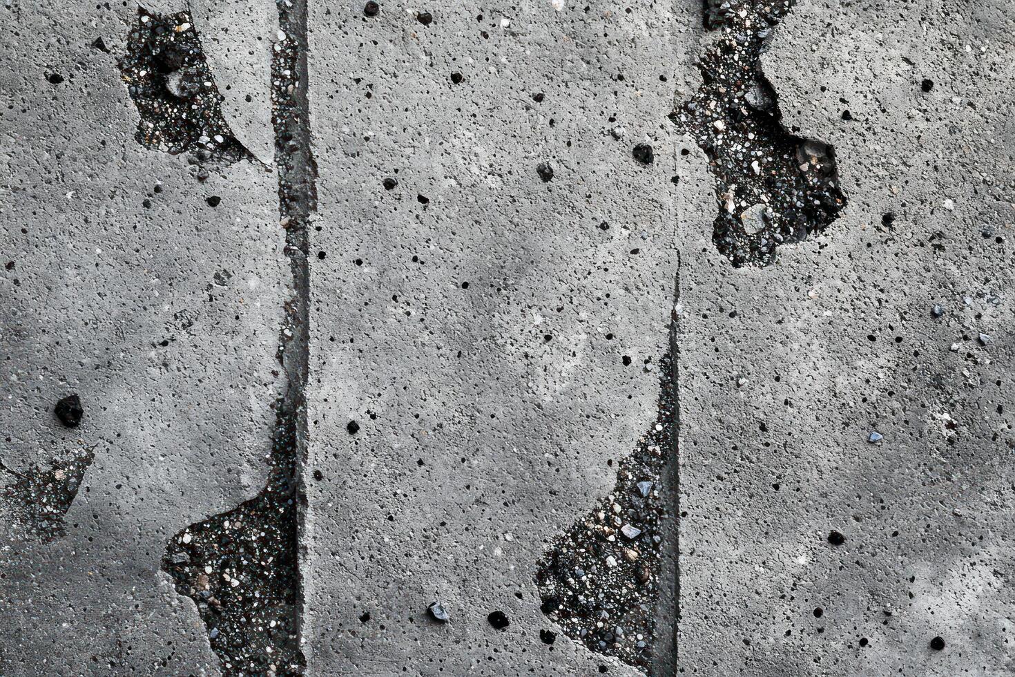 Weathered Concrete Surface with Cracks and Gravel photo