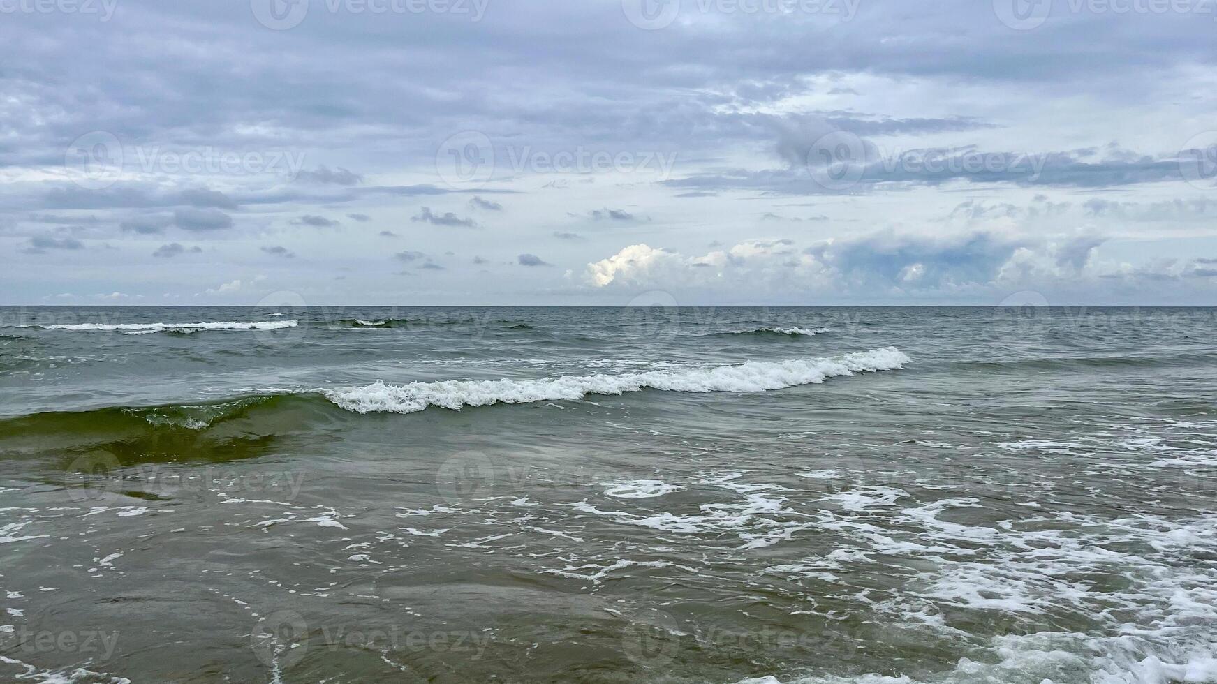 Seascape, stormy day on the Baltic Sea. Clouds meet the sea. photo
