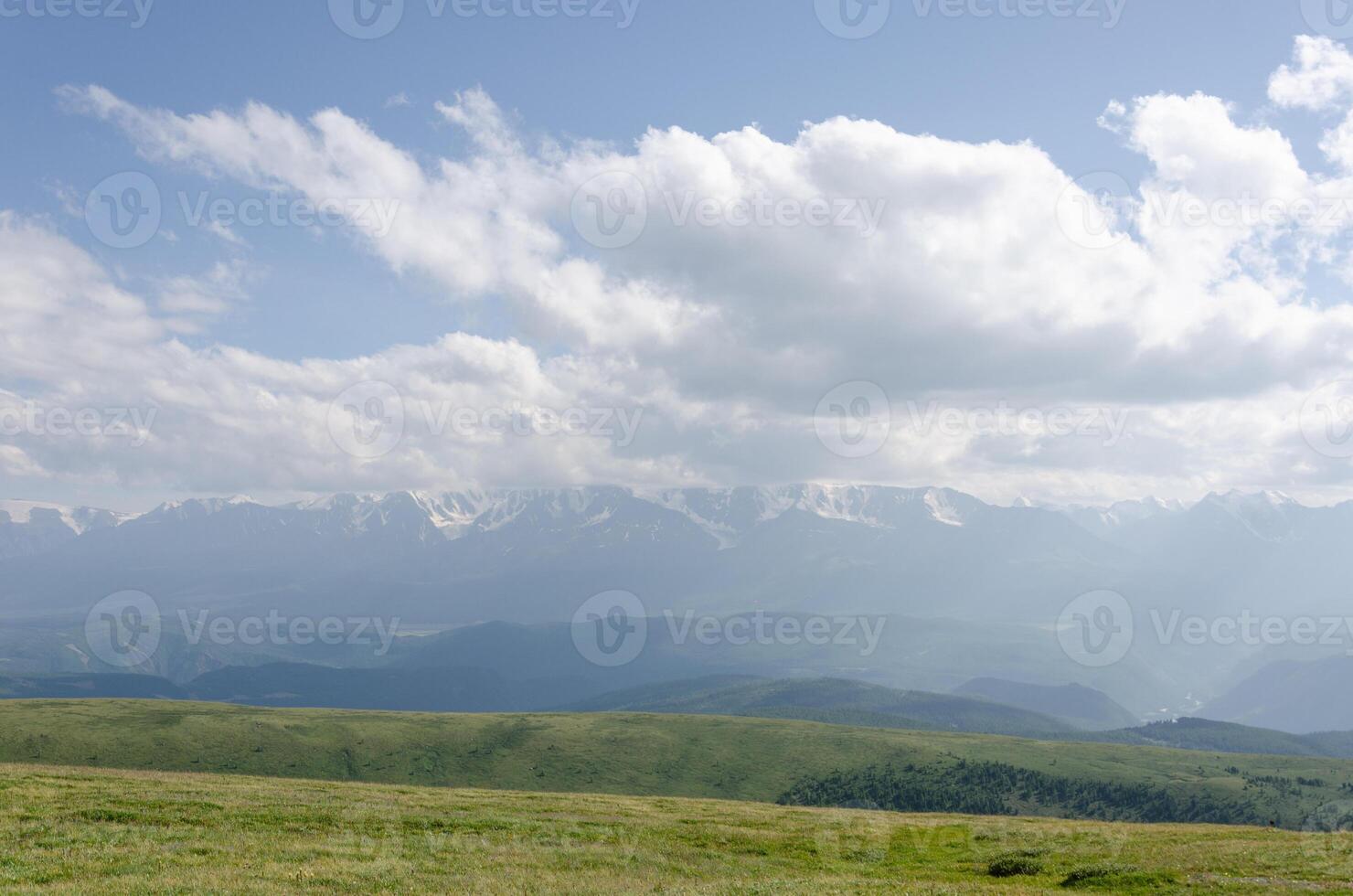 Mountain slopes with clouds on the sky covered with valley on top and mountains in Altay Russia early in the evening sunset. Hight quality horizontal photo