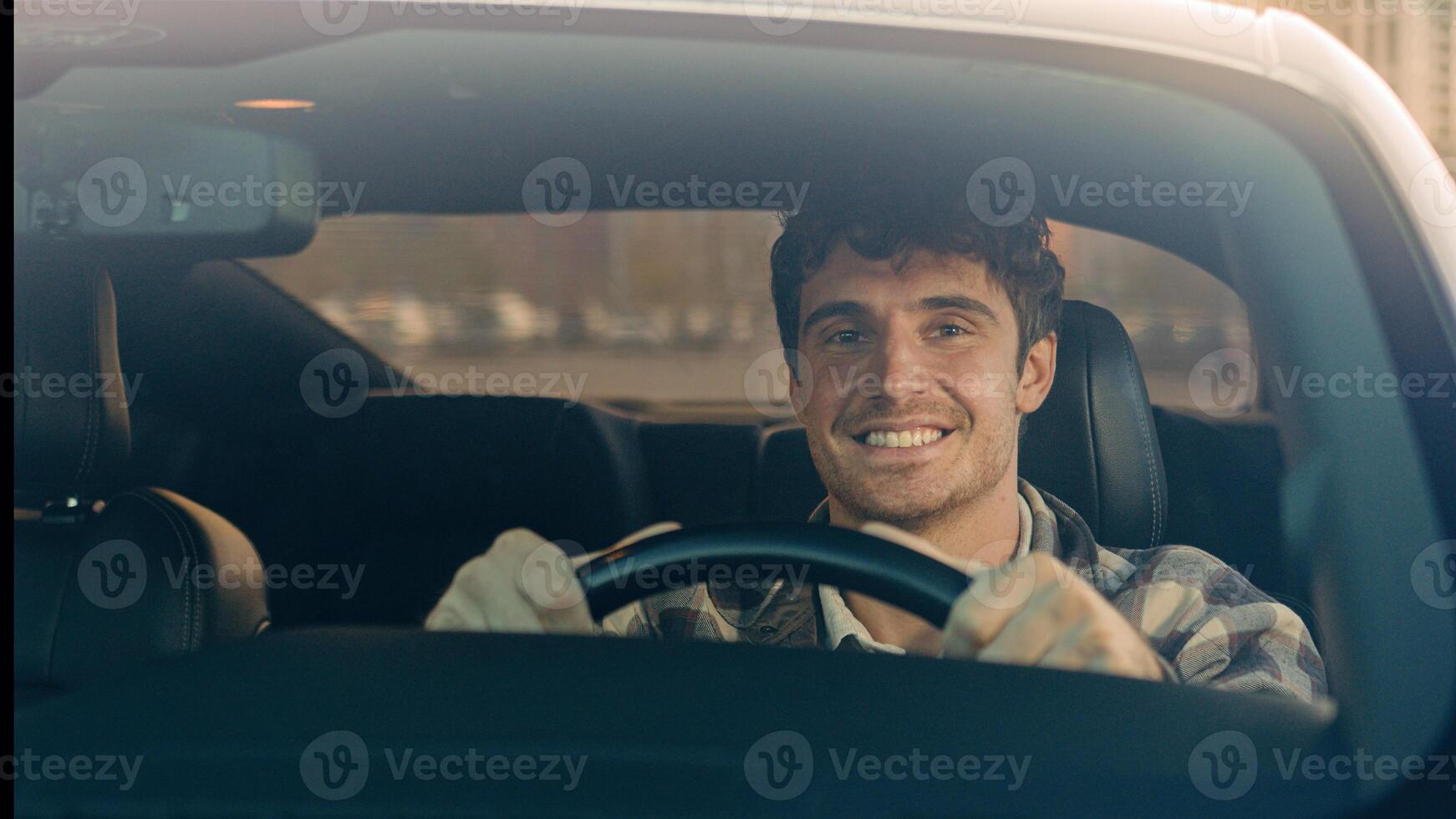 Happy Caucasian man car driver steering wheel enjoy travel trip drive modern electric automobile in city luxurious auto driving handsome guy smile inside suv crossover rent buy vehicle road adventure photo