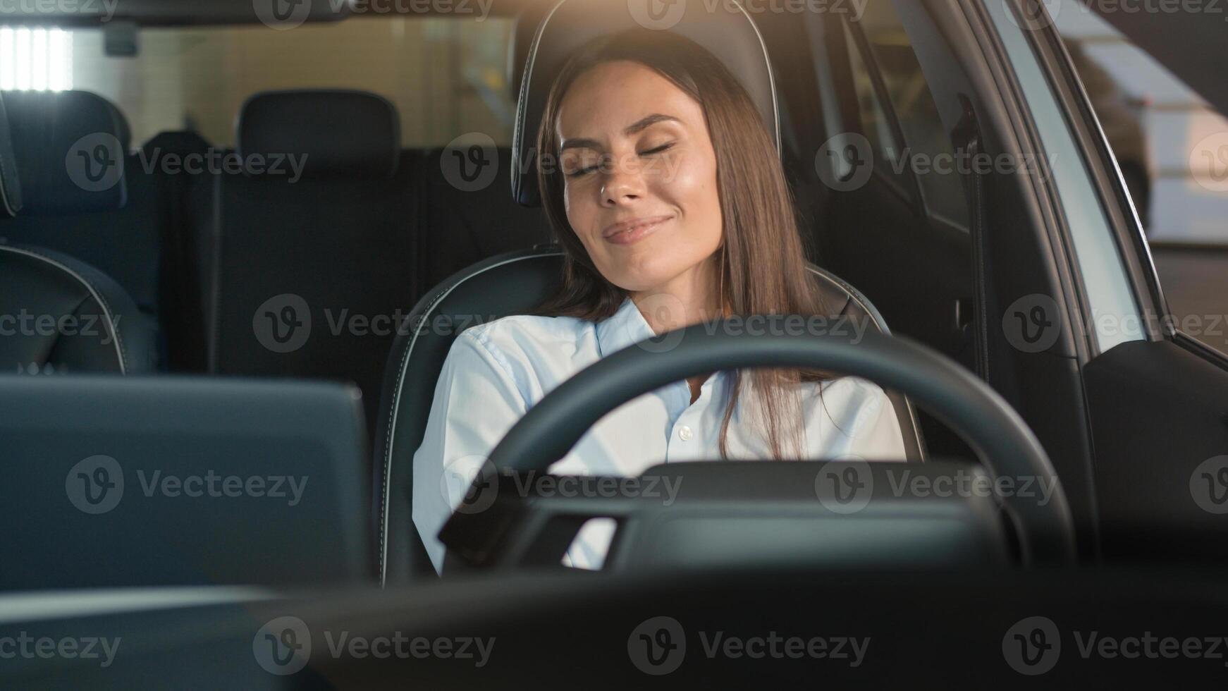 Happy Caucasian driver woman female client buyer girl sitting in car comfortable transport vehicle enjoying buying new automobile rent service shopping luxury purchase driving loan credit auto salon photo