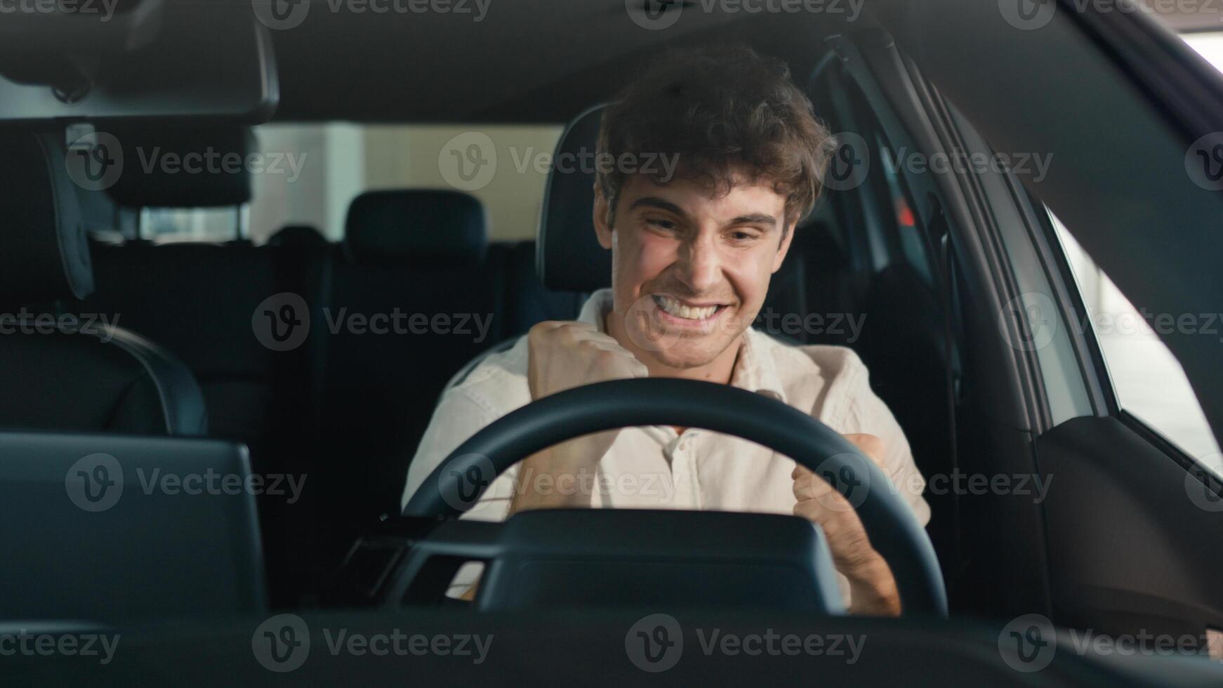 Smiling positive successful happy Caucasian man excited with new luxury car make winner hands gesture achieve triumph enjoy automobile buying male client buy vehicle transport celebrate sitting inside photo