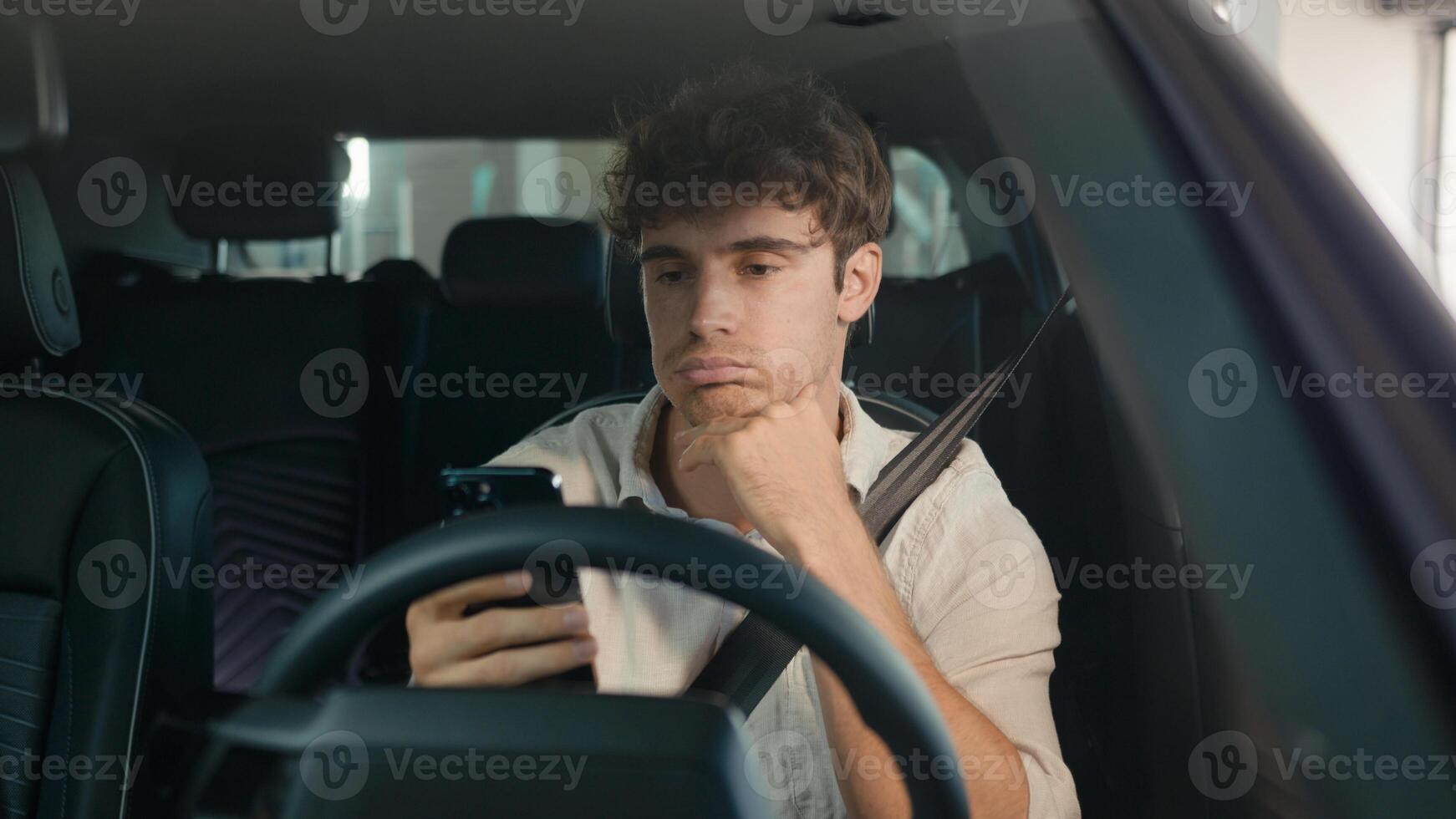 Caucasian confused sad driver upset puzzled male businessman frustrated man stressed business employer in car auto automobile parking lot traffic jam gadget addict lost problem bad news mobile phone photo