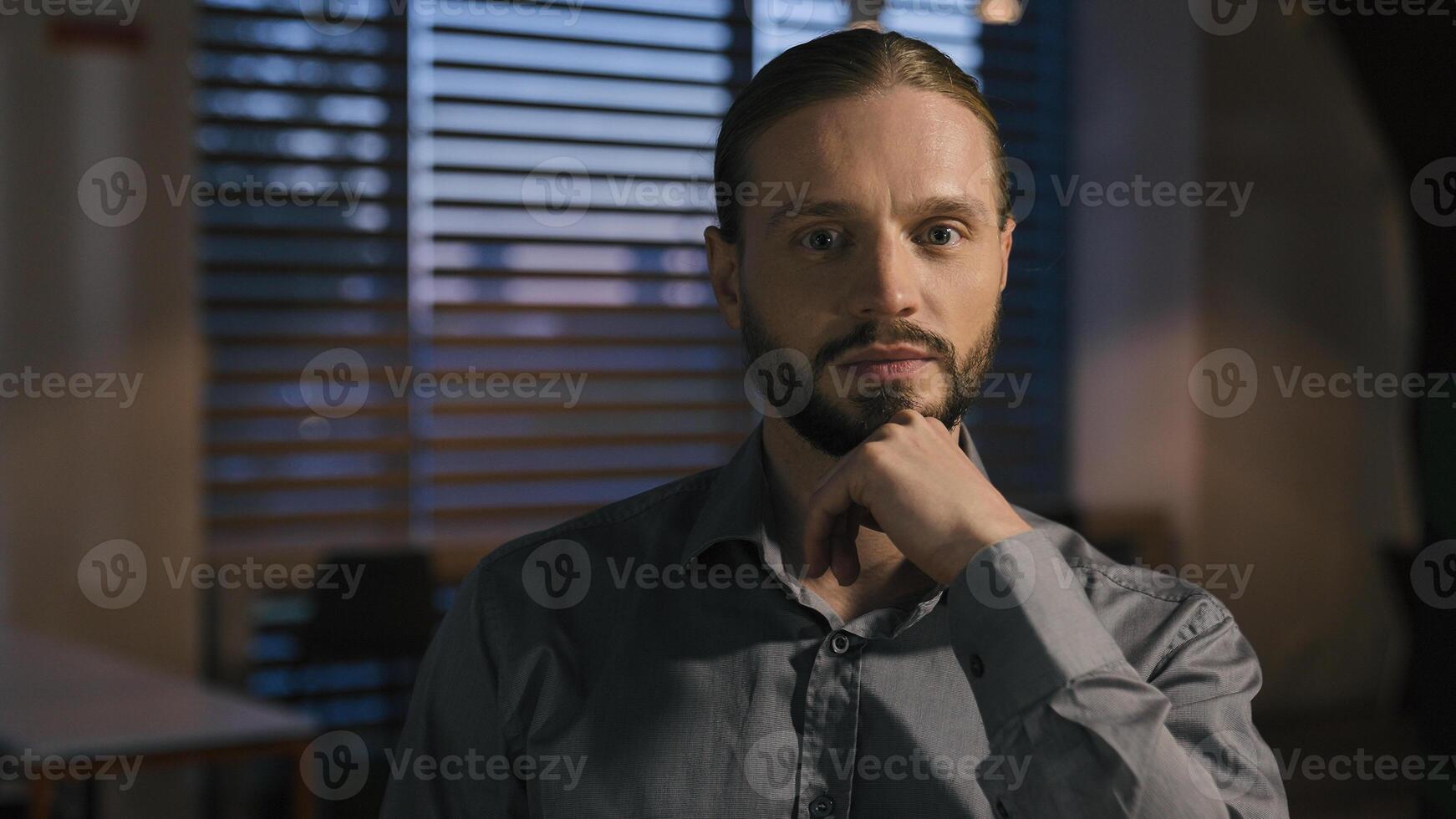 Caucasian business man pensive thinking evening office work looking at camera portrait businessman entrepreneur corporate CEO leader employer marketing manager solution thoughtful serious holding chin photo