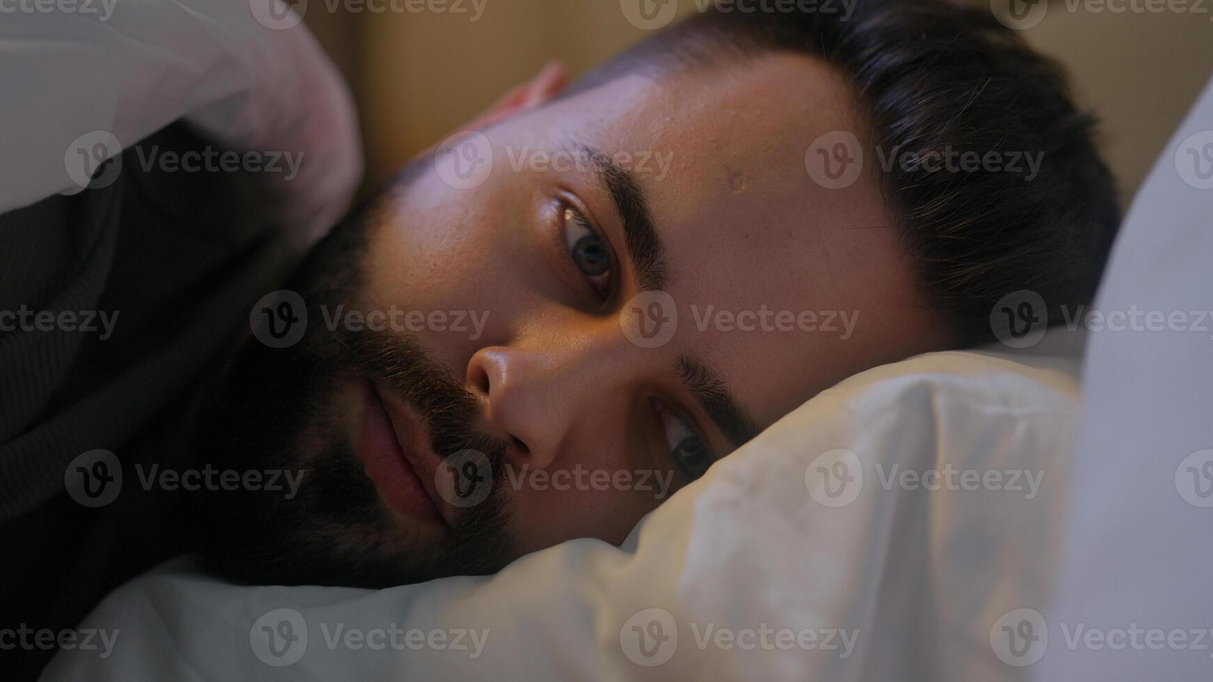 Caucasian man lying on bed trying sleep awake insomnia male guy late night bedroom home sleepless looking contemplation bedtime anxiety difficulty thinking disturbed sleeping problems worried medicine photo