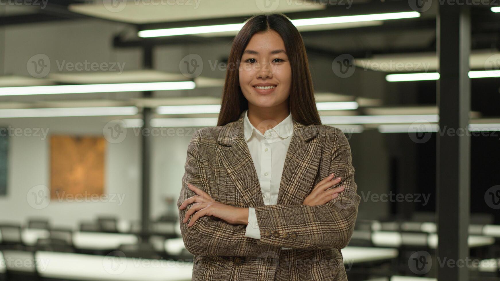 Asian businesswoman young Korean business woman confident smiling Chinese female employer Japanese entrepreneur lady girl posing hands crossed strong feminist manager company CEO leader in office photo