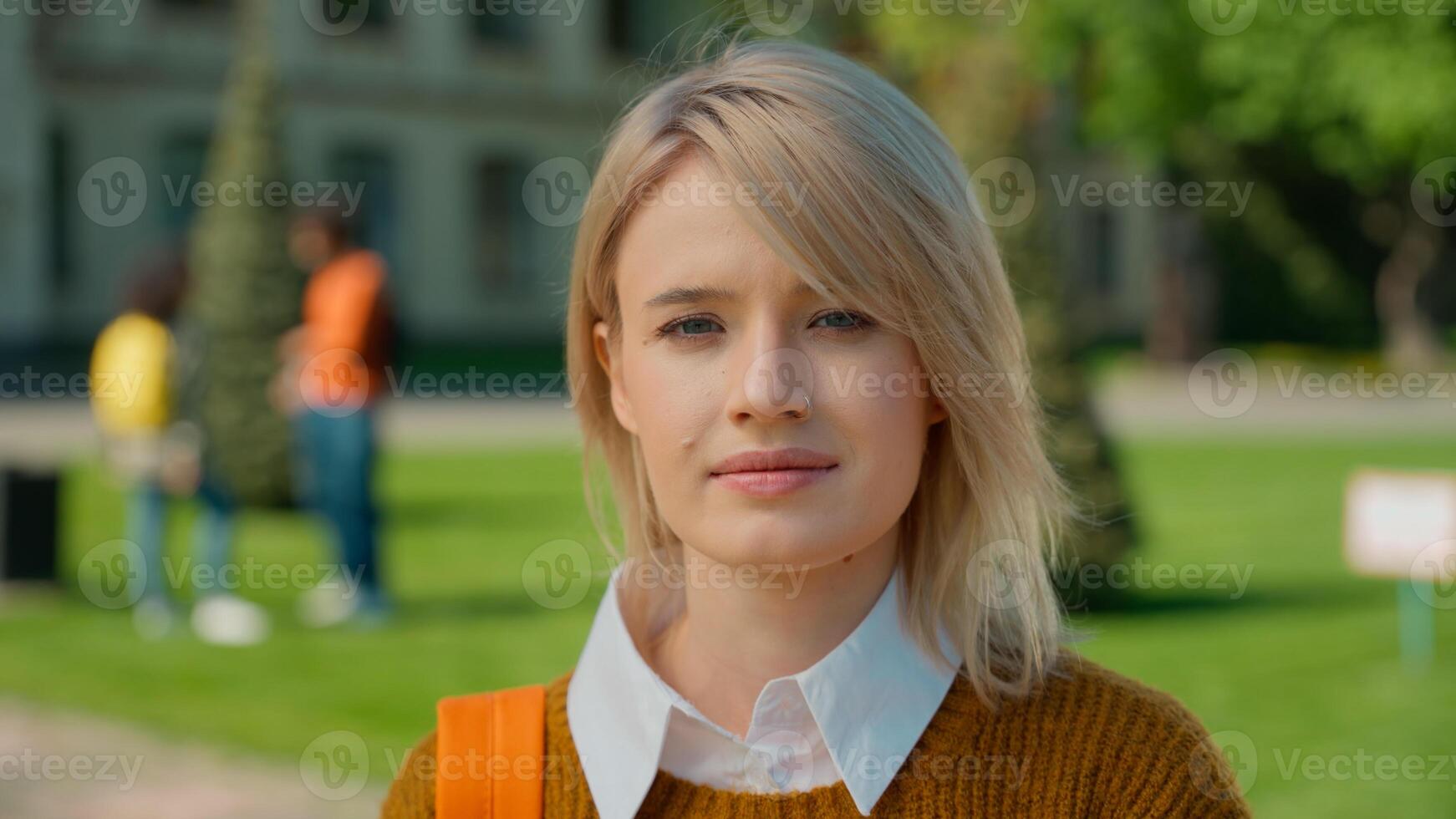 Portrait urban outdoor calm Caucasian student girl female woman lady pupil teen teenager standing in city outdoors university college high school academy campus education study learning holding book photo