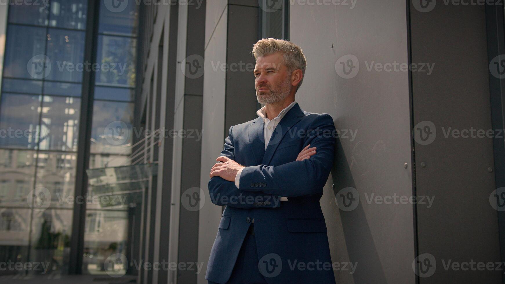 Smiling old senior Caucasian man mature retired middle-aged male employer business entrepreneur businessman good happy agree recommend showing thumb up gesture approval excellent result sign in city photo